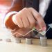Woman putting coins on stack with holding money, Concept business, finance, money saving and investment