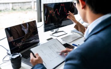 Business team investment working with computer, planning and ana Business team investment working with computer, planning and analyzing graph stock market trading with stock chart data, business financial investment and technology concept.