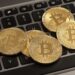 bitcoins-on-laptop-keyboard-stock-photos