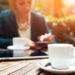 Cup,Of,Coffee,On,The,Foreground,With,Elegant,Young,Woman Cup,Of,Coffee,On,The,Foreground,With,Elegant,Young,Woman